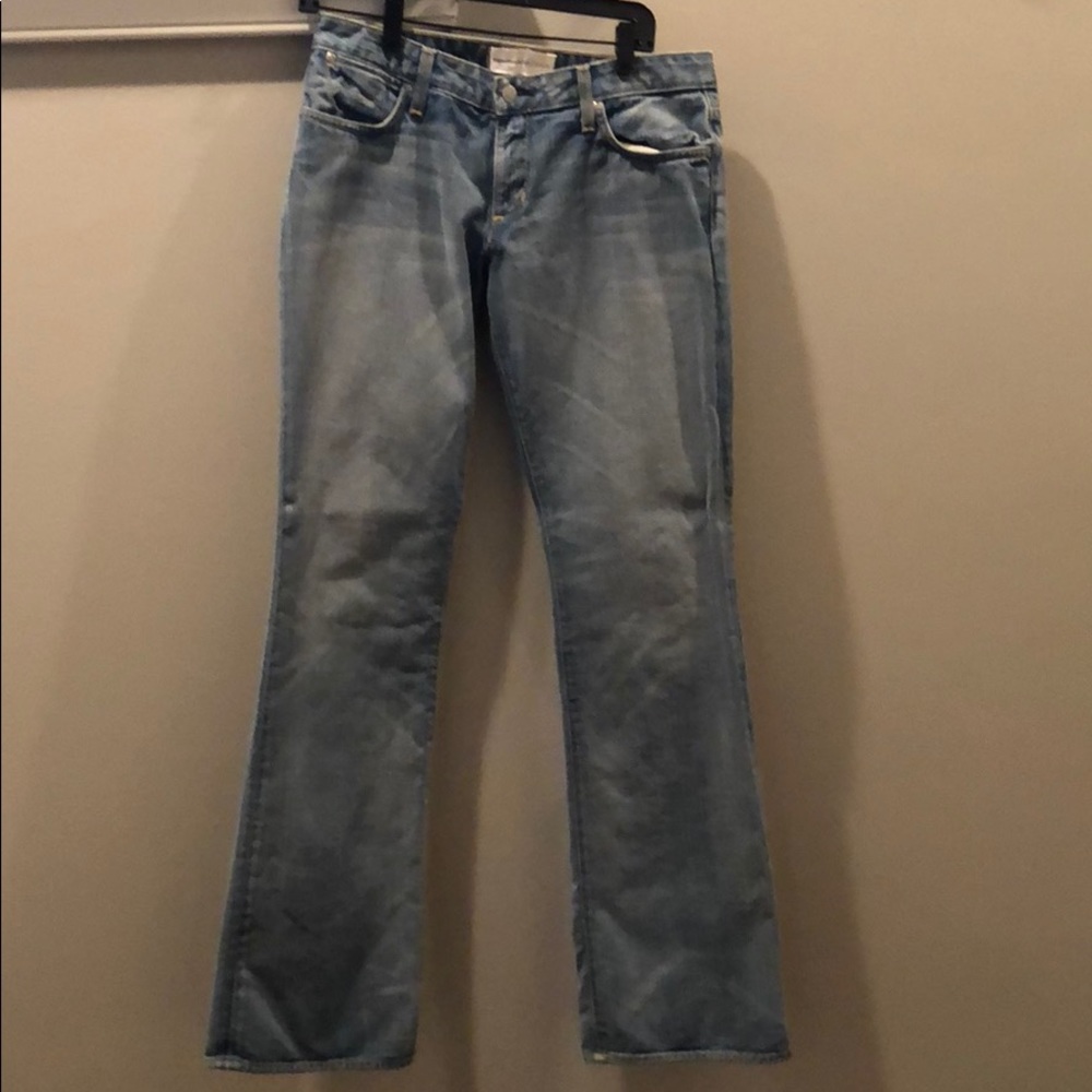 Faded blue jeans, low waisted, slightly flare